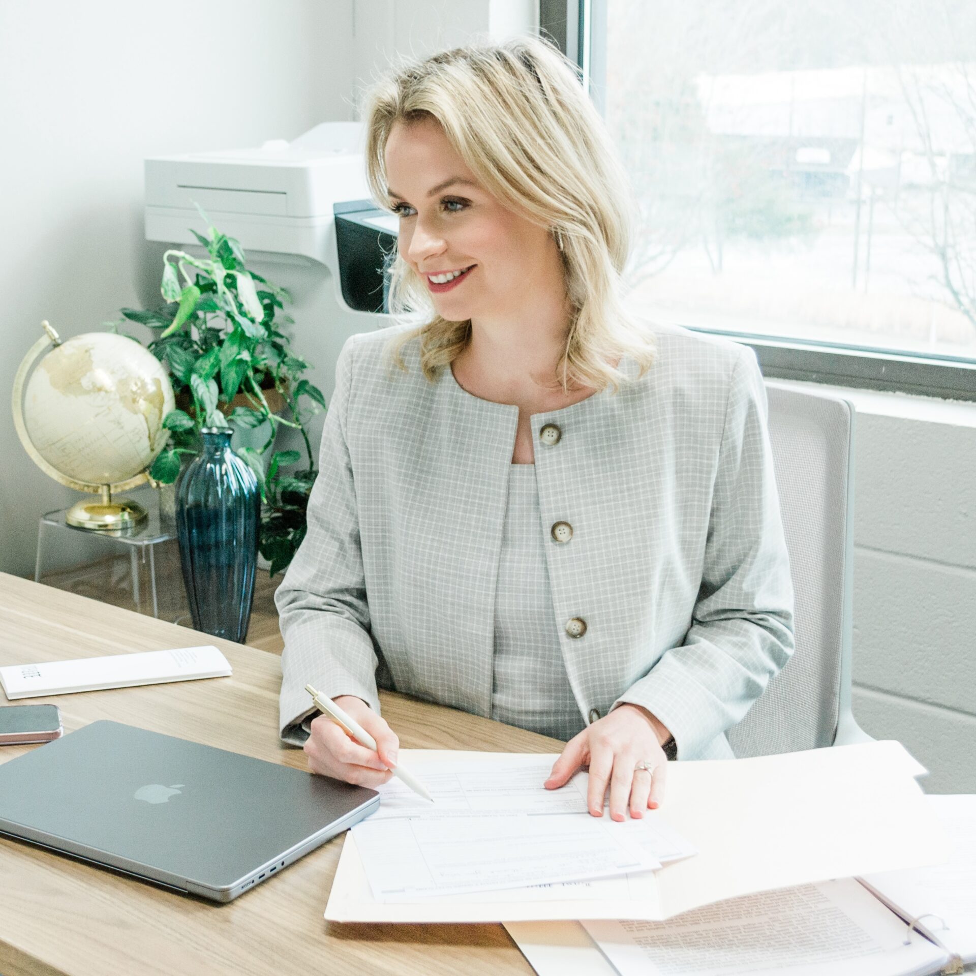 young couple signing lease agreement while having meeting with real estate